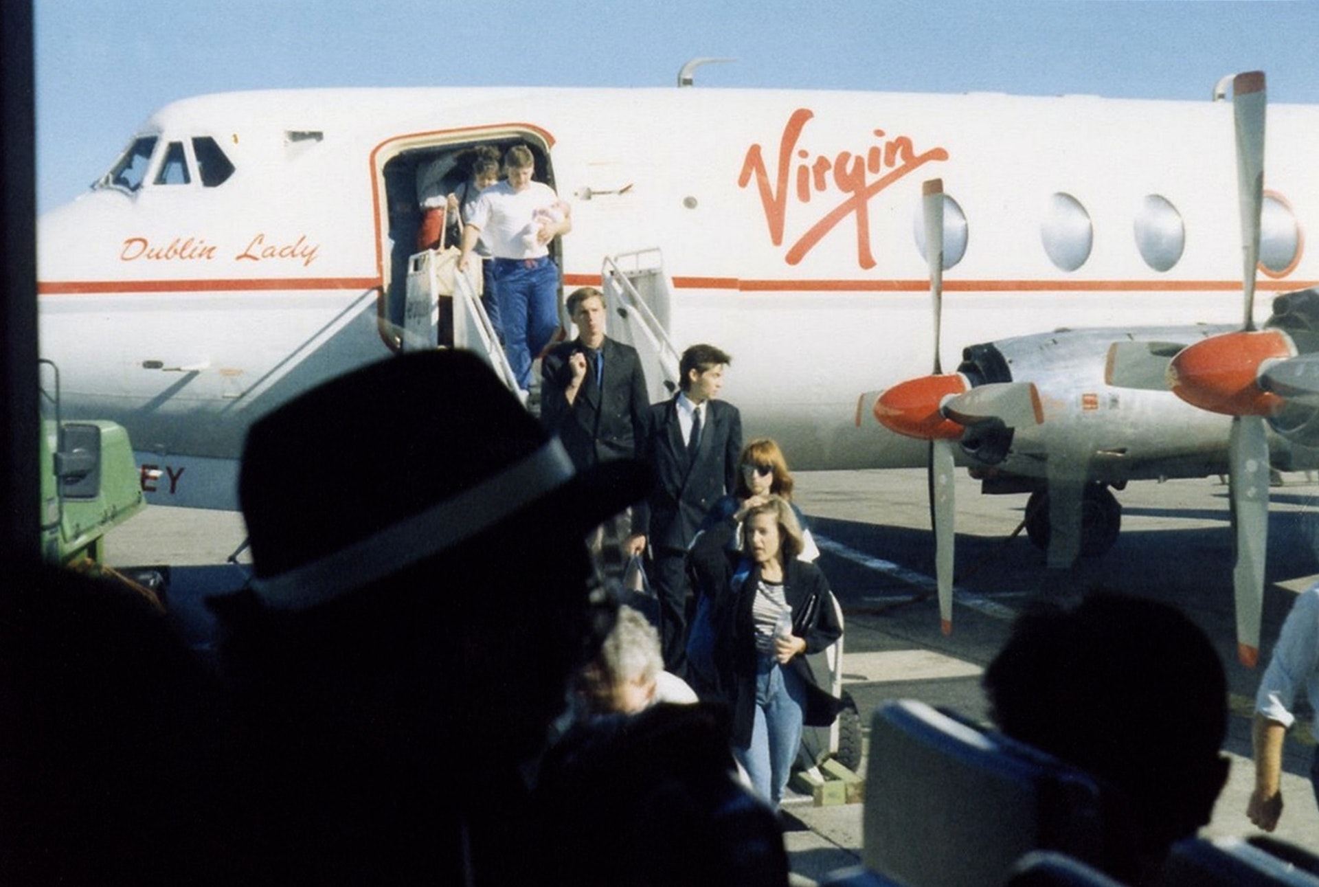 Travelers stepping off the 'Dublin Lady' Virgin plane, exemplifying the allure of emotional marketing in aviation and the joy of journeying with a brand that connects deeply with its passengers.