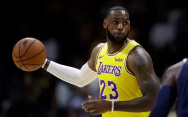 ChatGPT LeBron James, in his vibrant yellow Los Angeles Lakers jersey, showcases his "LeBron James Personal Brand" as he skillfully handles the basketball during a game.